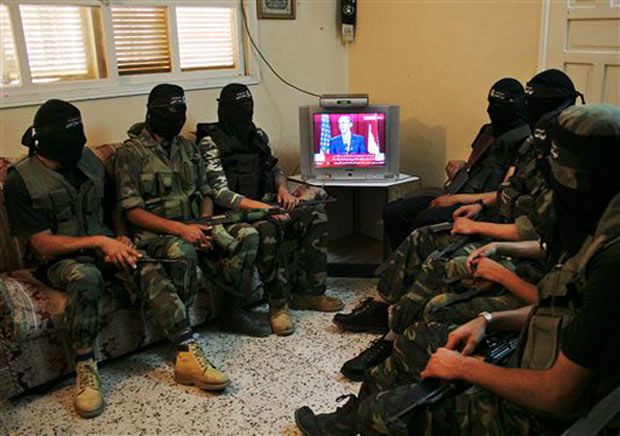 Palestinian militants from the Popular Resistance Committee watch Obama's speech.
